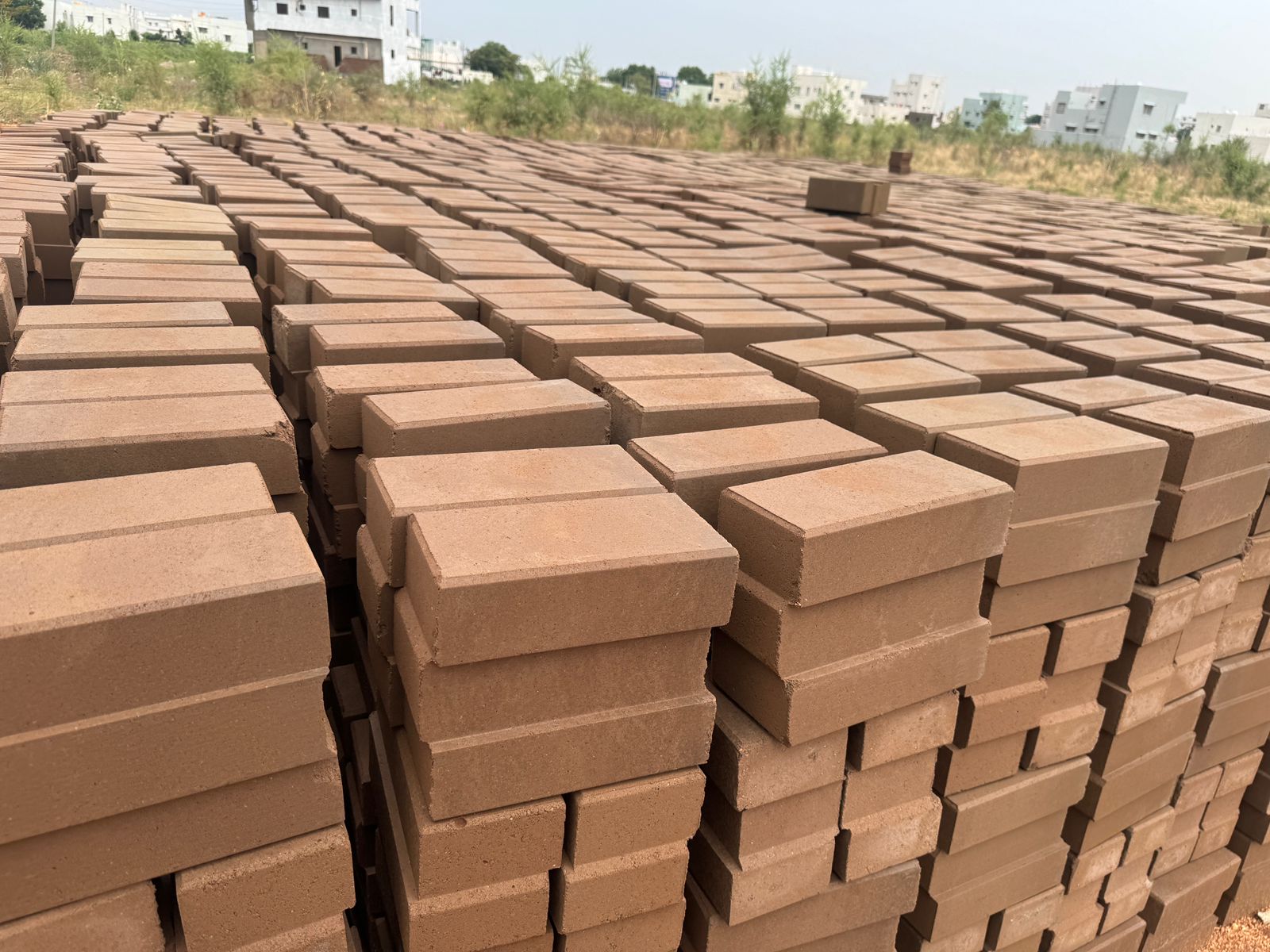 Close-up of interlocking bricks stacked in the yard